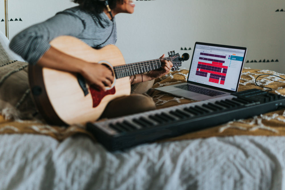 Person playing guitar in apartment with sound dampening features